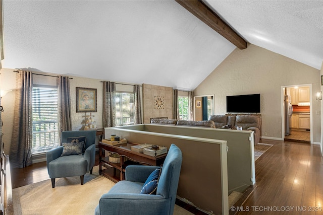 living room with lofted ceiling with beams, a textured ceiling, and hardwood / wood-style floors