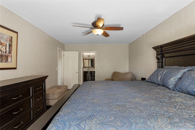 bedroom with ceiling fan and ensuite bath