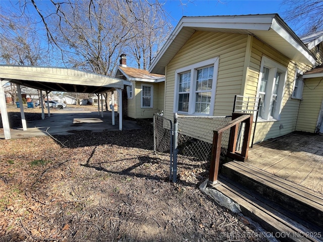 view of property exterior with a carport