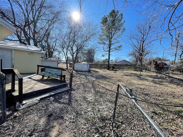 view of yard with a shed and a deck