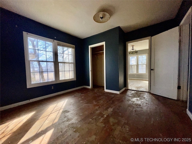 unfurnished bedroom featuring multiple windows