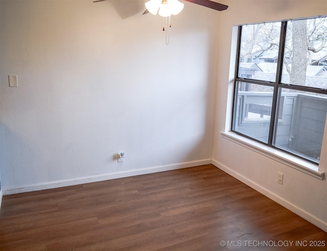 spare room featuring ceiling fan, wood finished floors, and baseboards