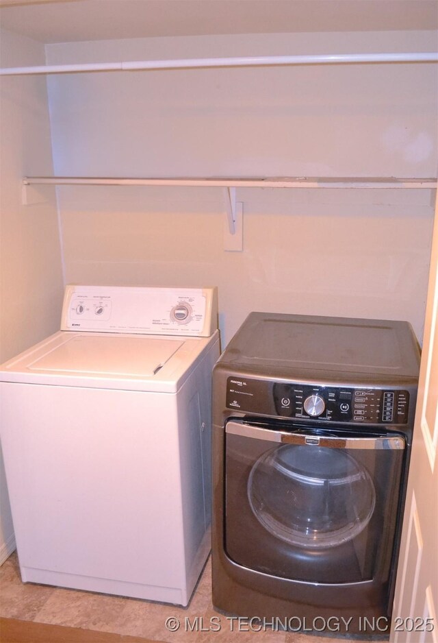 laundry area with washing machine and clothes dryer