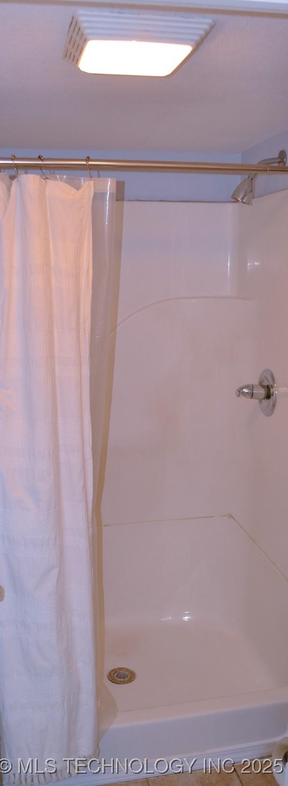 bathroom with curtained shower