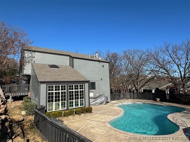 back of house featuring a fenced in pool and a patio