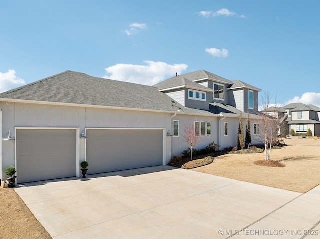 view of front of home with roof with shingles, an attached garage, driveway, and stucco siding