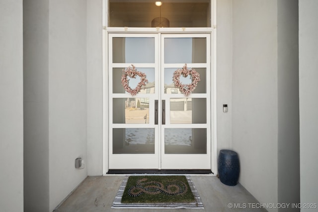 entrance to property featuring stucco siding