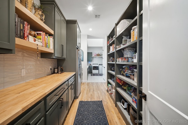 pantry featuring independent washer and dryer and visible vents