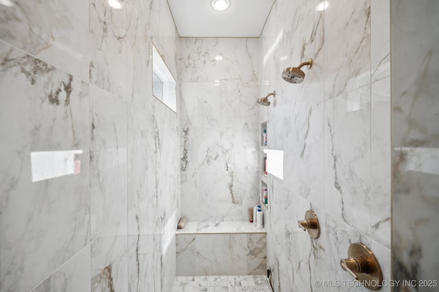 bathroom with tiled shower