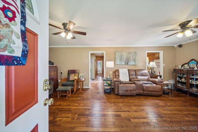 living room with crown molding, ceiling fan, and dark hardwood / wood-style flooring