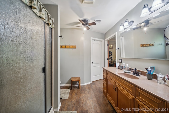 bathroom with a shower with door, vanity, hardwood / wood-style flooring, and ceiling fan