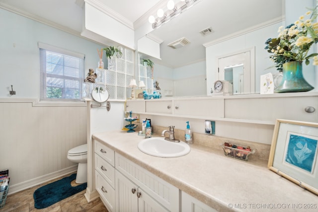 bathroom featuring crown molding, vanity, and toilet