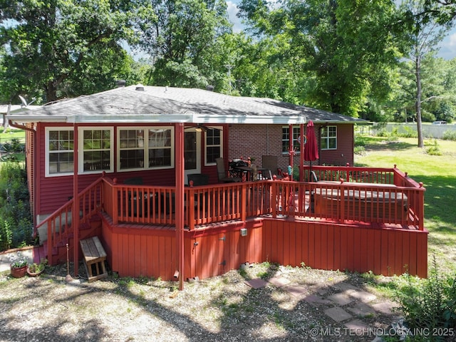 rear view of property with a wooden deck