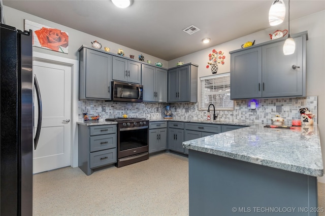 kitchen with sink, appliances with stainless steel finishes, kitchen peninsula, pendant lighting, and decorative backsplash