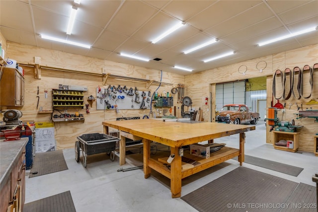 interior space featuring a paneled ceiling and a workshop area