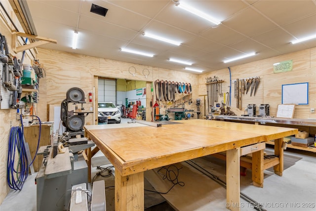 interior space featuring a drop ceiling and a workshop area