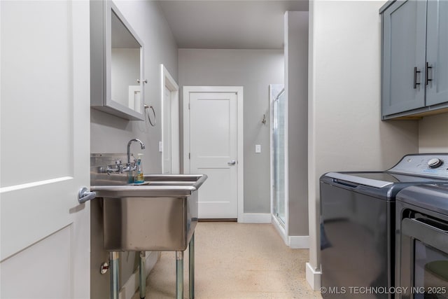 laundry room featuring cabinets and washing machine and dryer