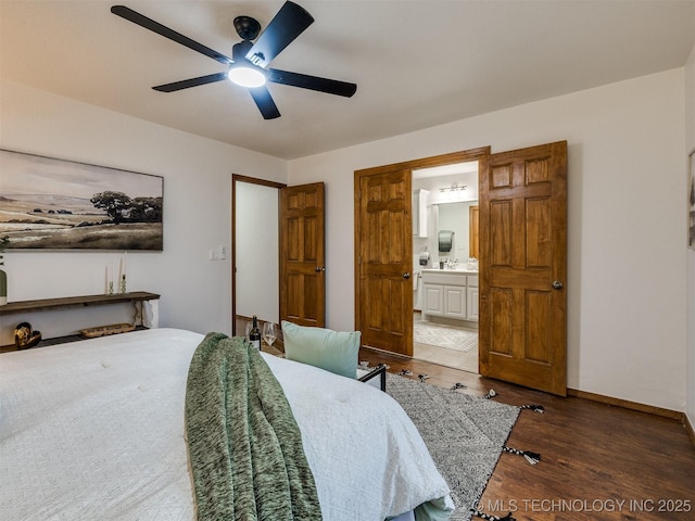 bedroom featuring ceiling fan, dark hardwood / wood-style floors, and ensuite bath