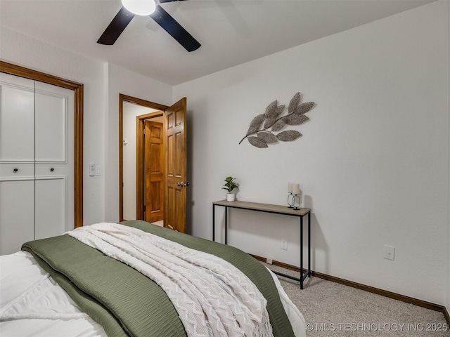 carpeted bedroom with ceiling fan and a closet