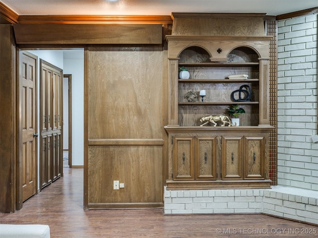 bar featuring wood-type flooring and ornamental molding