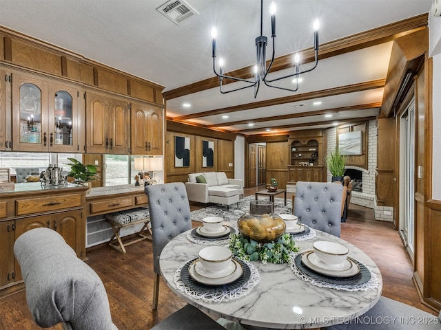 dining area with a fireplace, wood walls, and dark hardwood / wood-style flooring