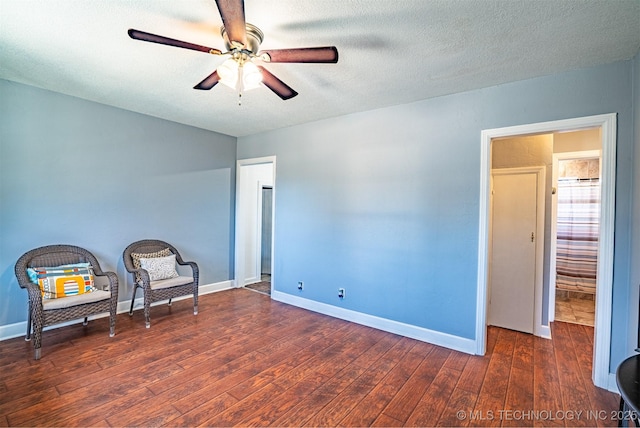 unfurnished room featuring ceiling fan, a textured ceiling, and dark hardwood / wood-style flooring