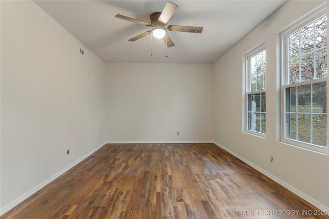 unfurnished room with ceiling fan and dark hardwood / wood-style flooring