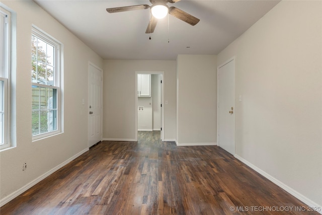 empty room featuring ceiling fan and dark hardwood / wood-style floors