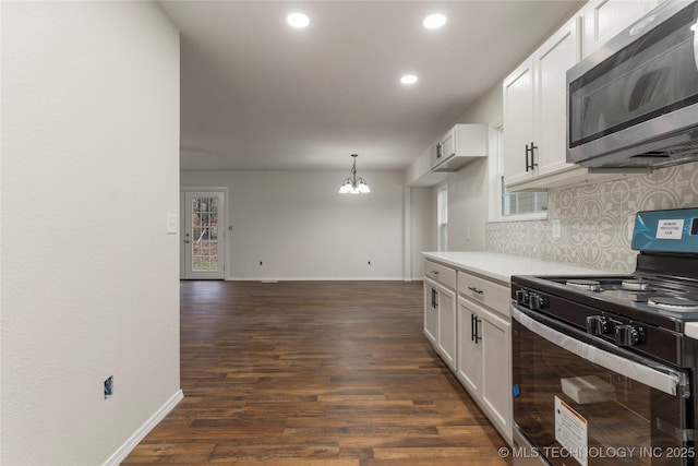 kitchen with backsplash, white cabinets, a notable chandelier, and gas stove