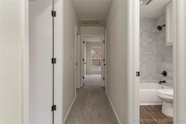 hallway featuring carpet flooring