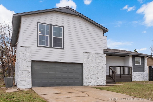 view of property exterior with a garage and cooling unit