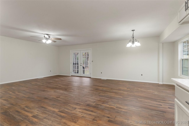 spare room featuring french doors, a wealth of natural light, and dark hardwood / wood-style flooring