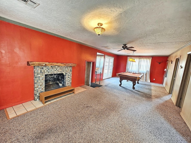 recreation room with a textured ceiling, pool table, light carpet, a fireplace, and ornamental molding