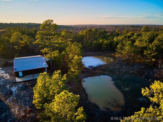 aerial view at dusk with a water view