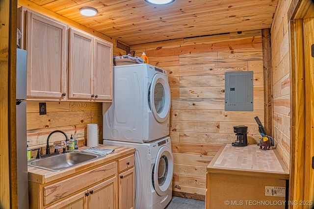 clothes washing area featuring wood walls, electric panel, wooden ceiling, and stacked washer and dryer