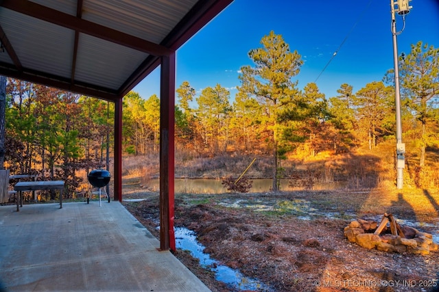 view of yard featuring an outdoor fire pit and a patio area