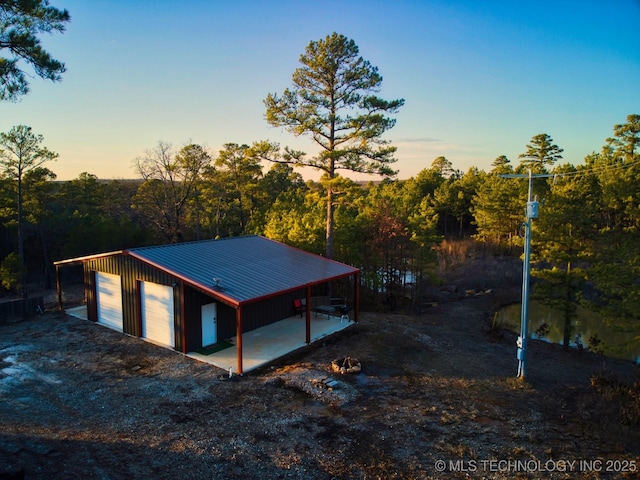 exterior space with an outbuilding and a garage