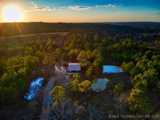 aerial view at dusk with a water view