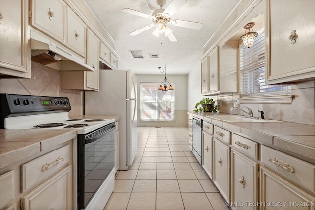 kitchen with dishwasher, sink, hanging light fixtures, light tile patterned floors, and electric stove