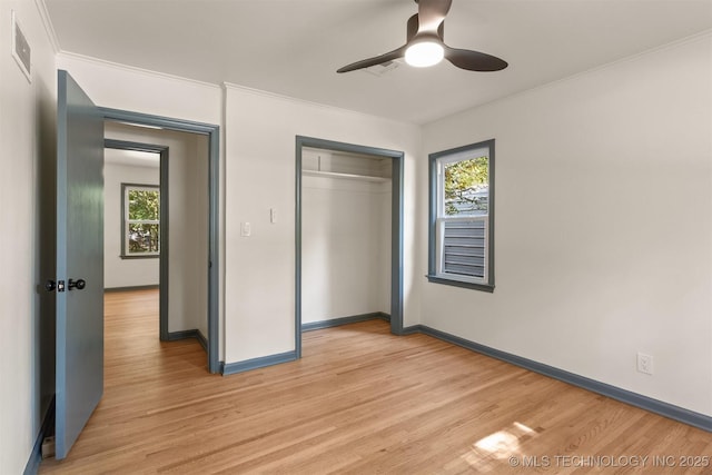 unfurnished bedroom featuring light hardwood / wood-style floors, a closet, and ceiling fan