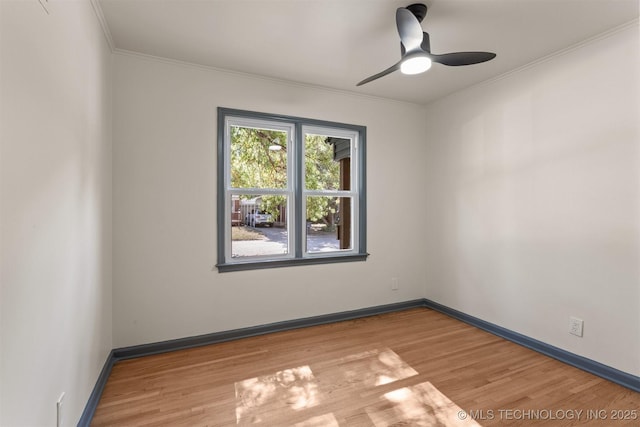 spare room with ceiling fan, ornamental molding, and light wood-type flooring