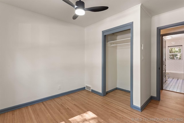 unfurnished bedroom featuring a closet, ceiling fan, hardwood / wood-style floors, and ornamental molding