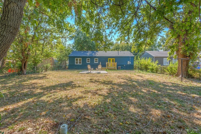 rear view of property featuring a lawn and a patio