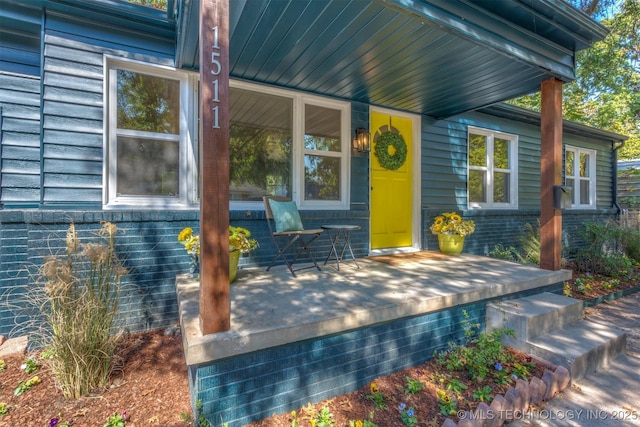 view of exterior entry with a porch