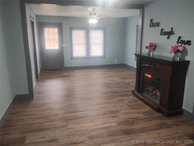 interior space featuring ceiling fan and dark wood-type flooring