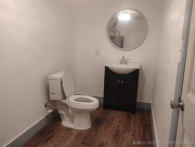 bathroom featuring hardwood / wood-style floors, toilet, and vanity