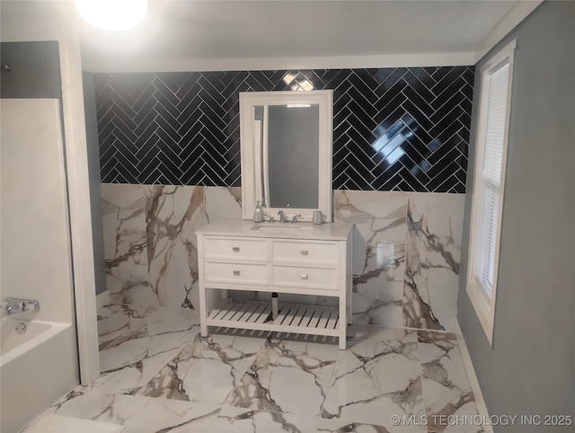 bathroom featuring tile walls, a bath, and vanity