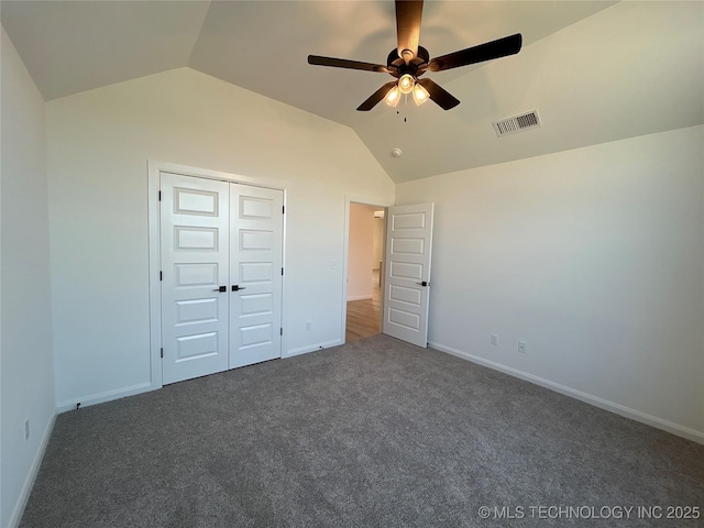 unfurnished bedroom featuring carpet flooring, baseboards, vaulted ceiling, and visible vents