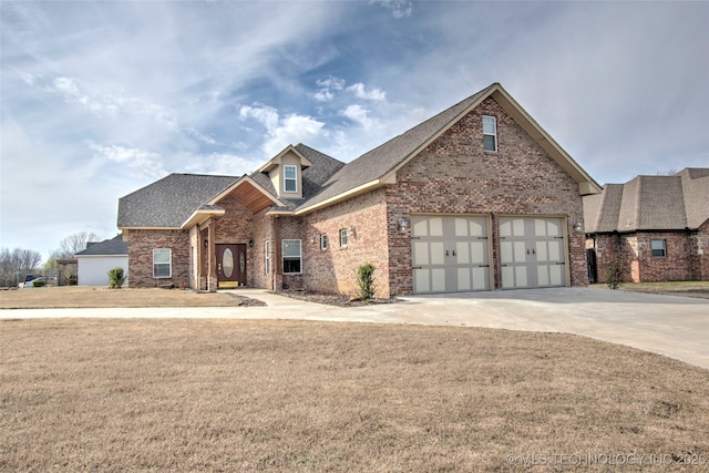 view of front facade featuring a front yard and a garage