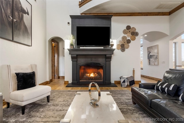 interior space featuring crown molding and light hardwood / wood-style floors